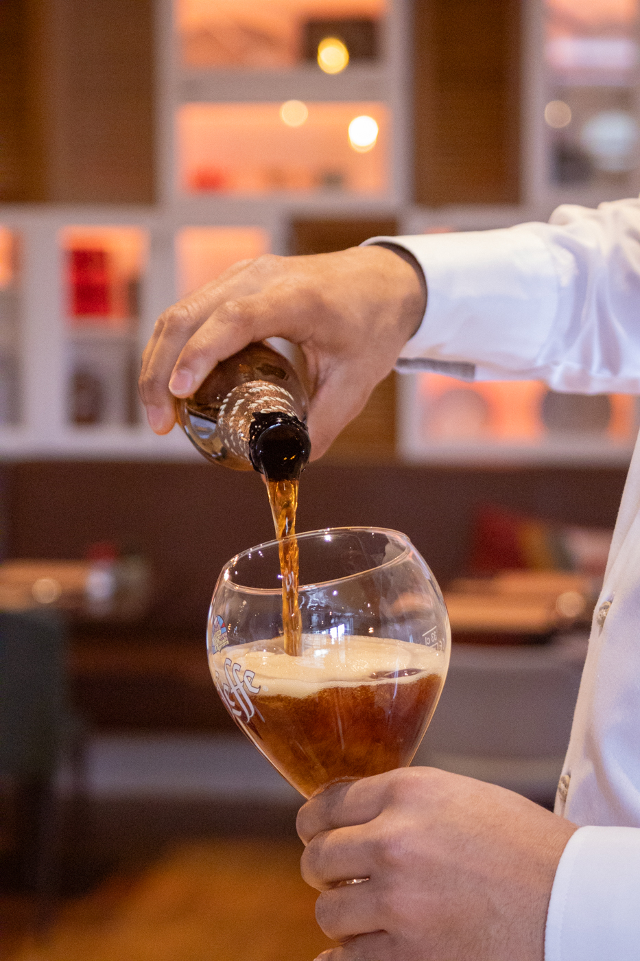 Bartender serving a beer in a hotel restaurant